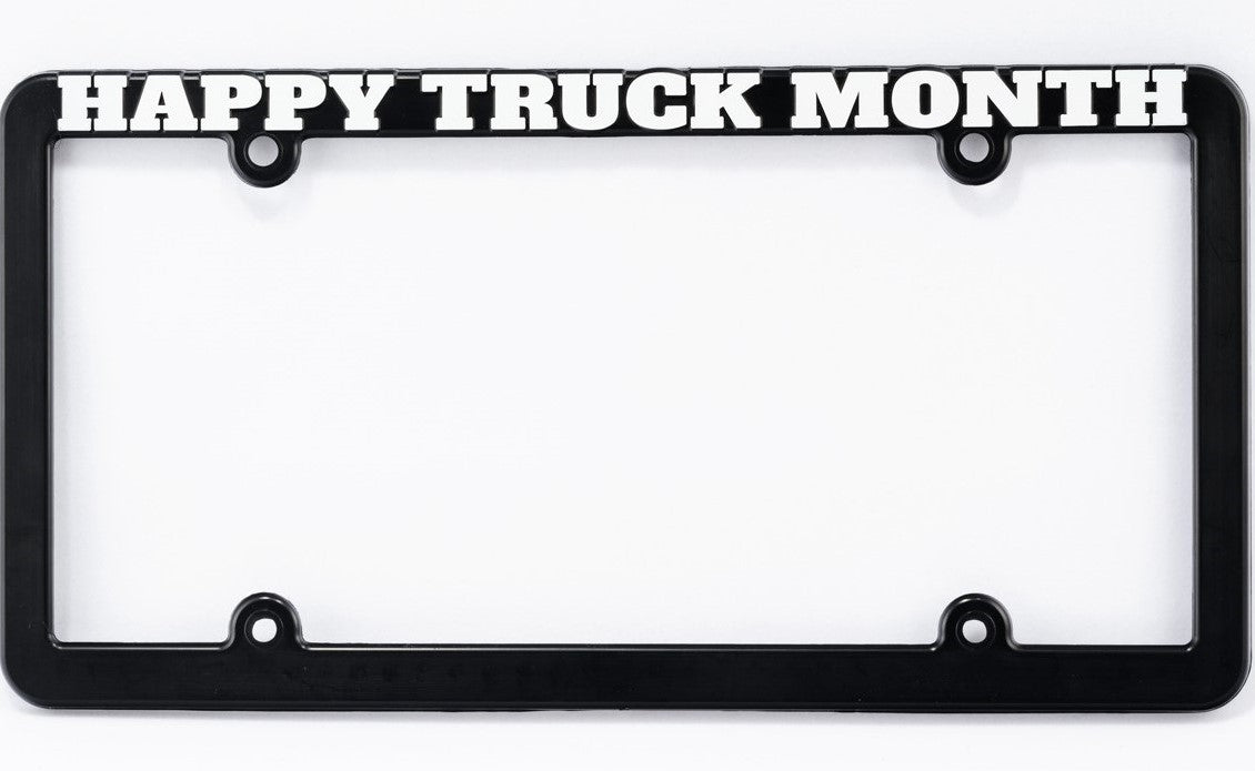 A black license plate frame with the words HAPPY TRUCK MONTH in bold white letters at the top.