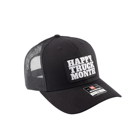 Black trucker hat with Happy Truck Month patch on a white background