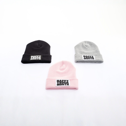Three beanies in black, pink, and gray with 'Happy Truck Month' text on a white background