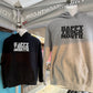 Two hoodies hanging under a canopy at w a market stall: a black hoodie on the left with white text reading 'HAPPY TRUCK MONTH.' and an athletic gray hoodie on the right with black text reading 'HAPPY TRUCK MONTH.